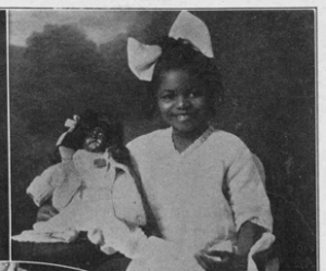 A brownie of Norfolk, Va., was a prize winner in the contest conducted by the Berry & Ross Manufacturing Company of New York City. The subject was, "Why Should a Colored Child Play with a White Doll?" And here we see little Catherine Bynum with her prize, a sleeping, brown-skinned doll. Catherine is eight years old and attends the John C. Price Public School. She is in the third grade.